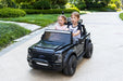 children driving a black Ford