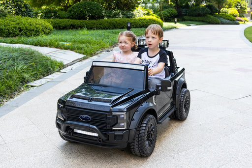children driving a black Ford